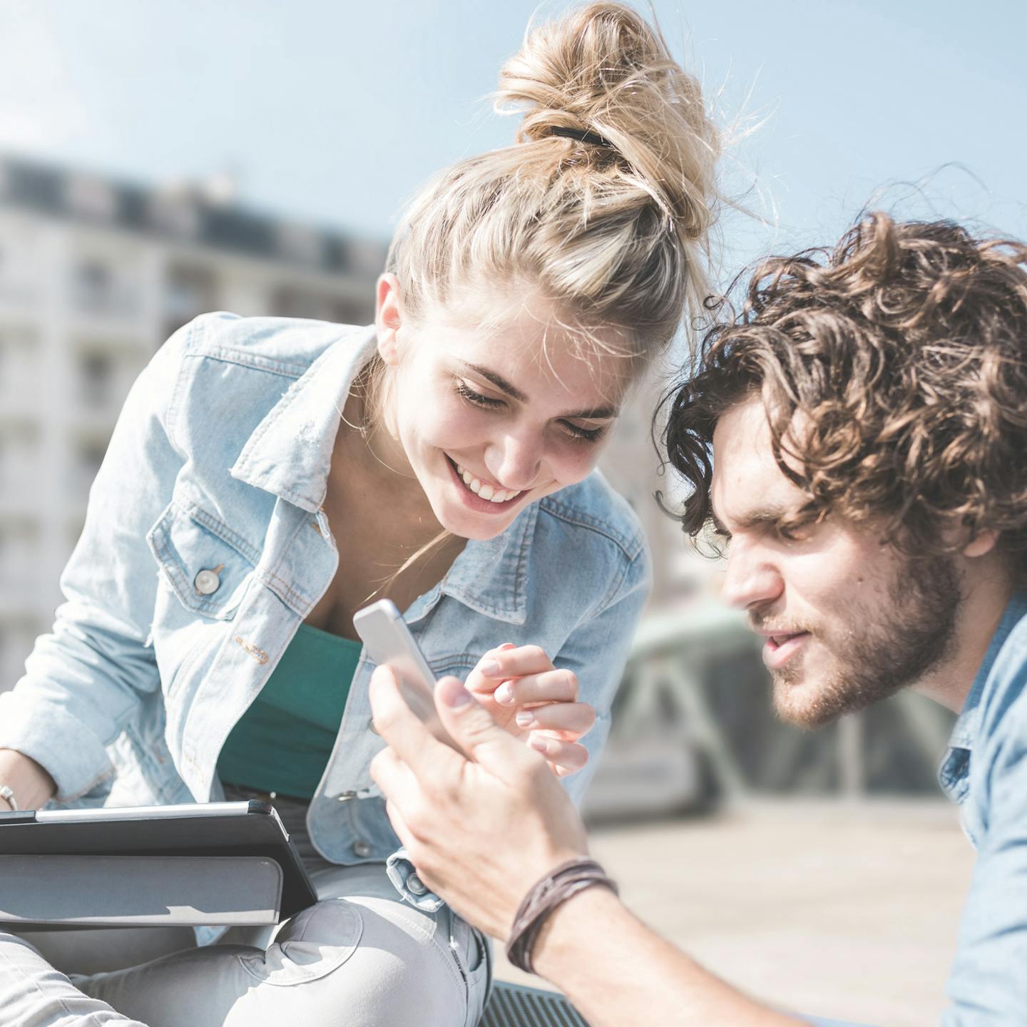 Couple making a mobile payment transaction orchestrated by a payment orchestration platform